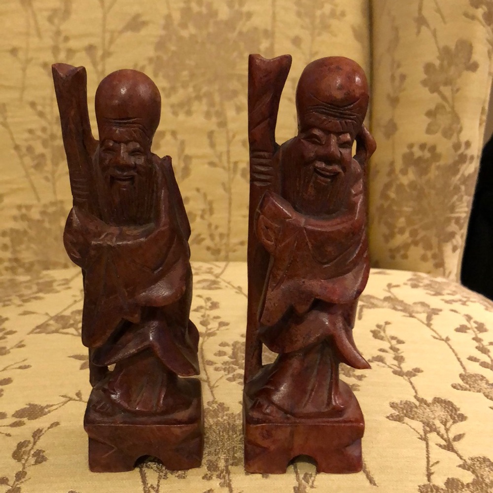 Two carved oriental-looking wood statues.